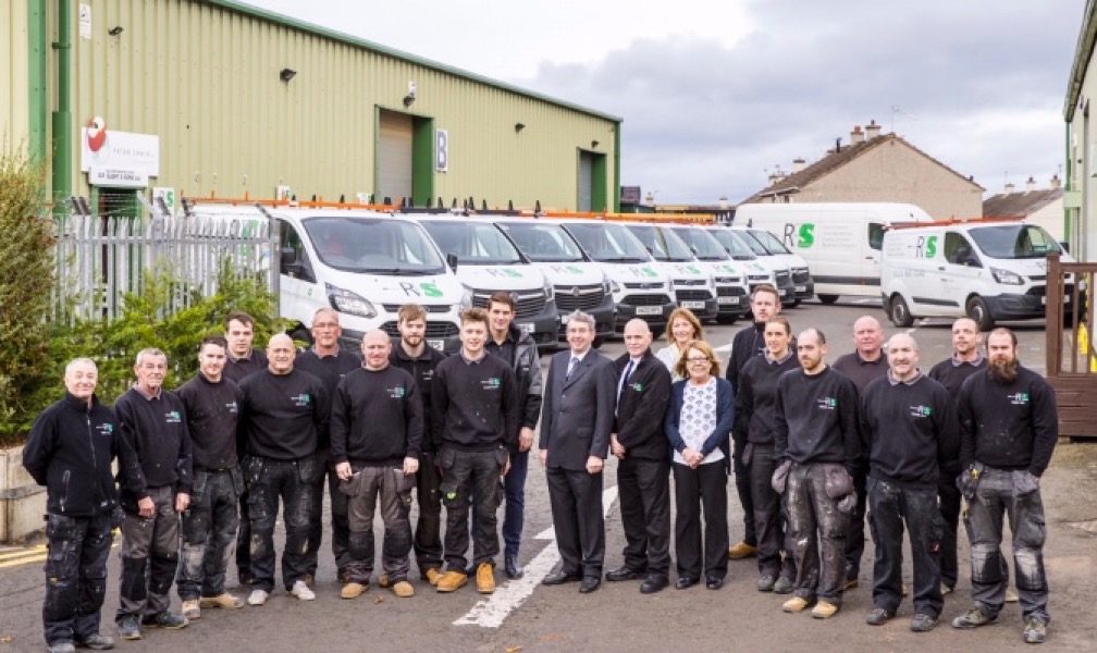 RP Slight and Sons team in front of van fleet